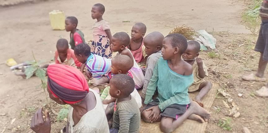 Ugandan community in warm sunlight, families and children gathered outdoors, deep shadows, rich earth tones